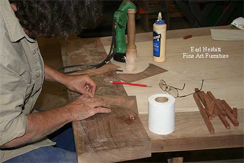 Earl pegging tenons at one end of a custom made dining table